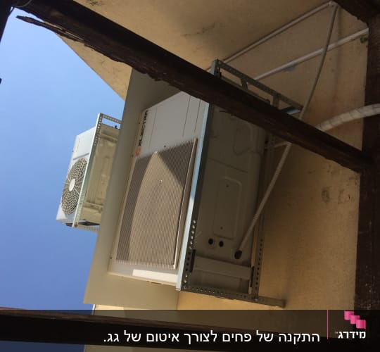 יחידת מיזוג אוויר מותקנת על קיר עם צינורות אטומים